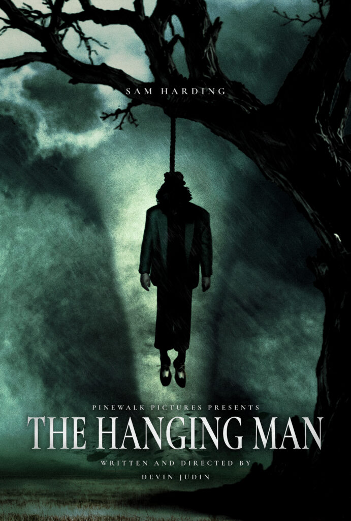 Key art for The Hanging Man, showing a silhouetted figure hanging from a barren tree against a stormy green sky.